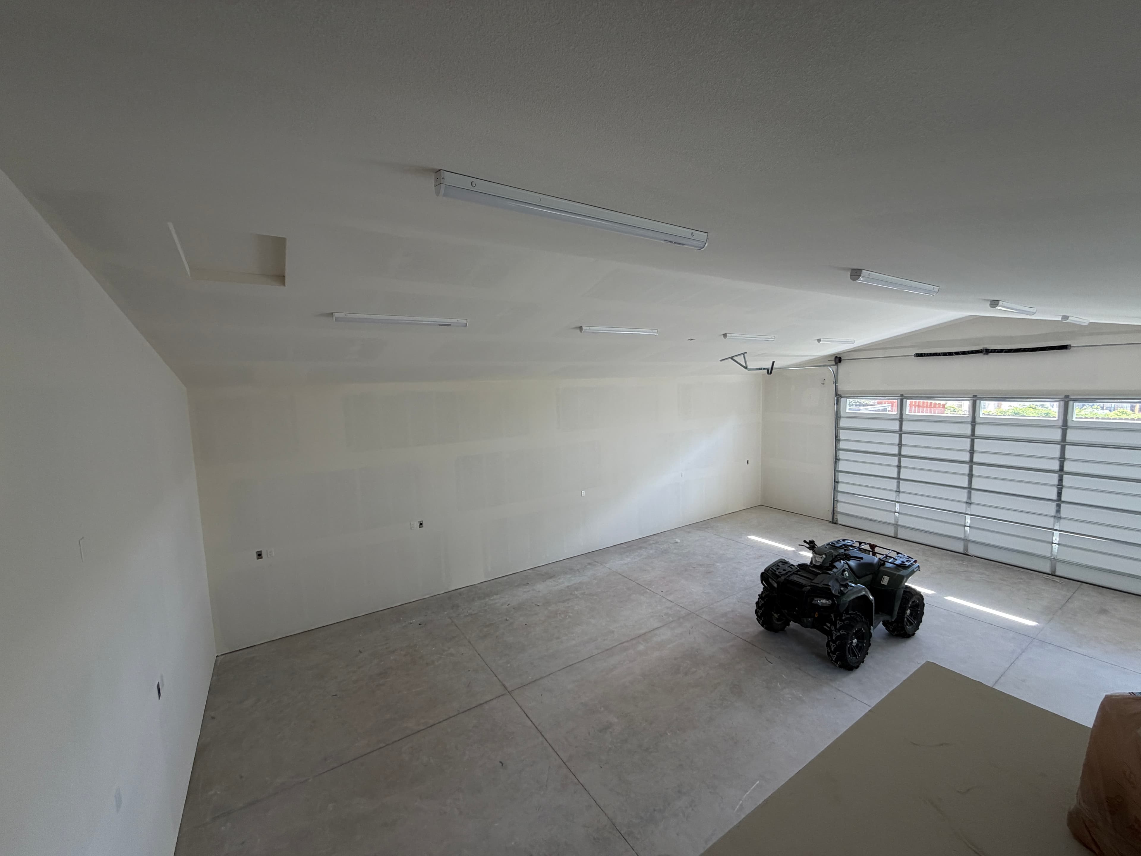 Completed electrical build-out for a 40 by 40 detached garage in Reno with lighting, receptacles, 240-volt circuits, bathroom power, and electrical panel