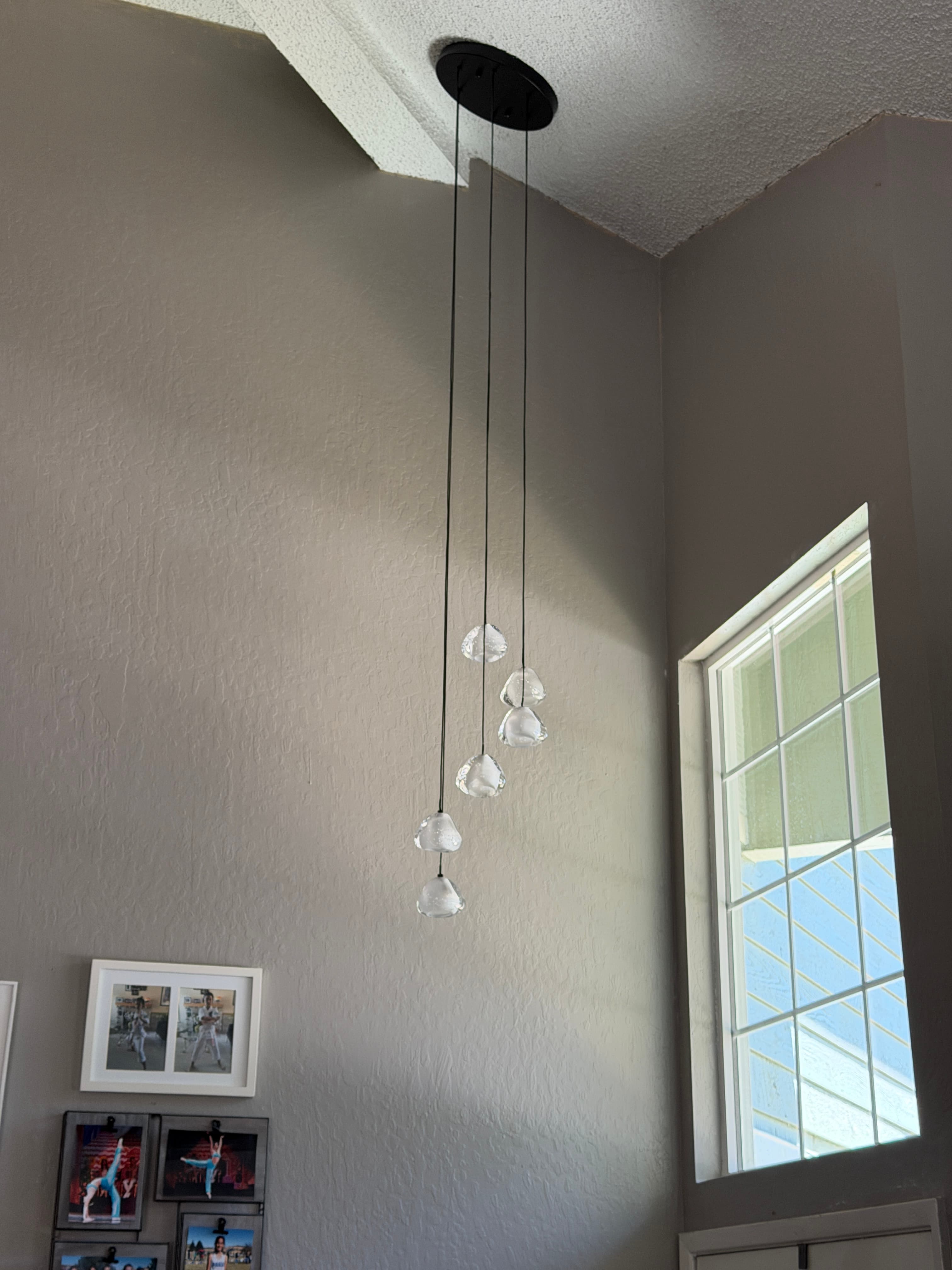 Modern pendant light installed in a high-ceiling Reno entryway